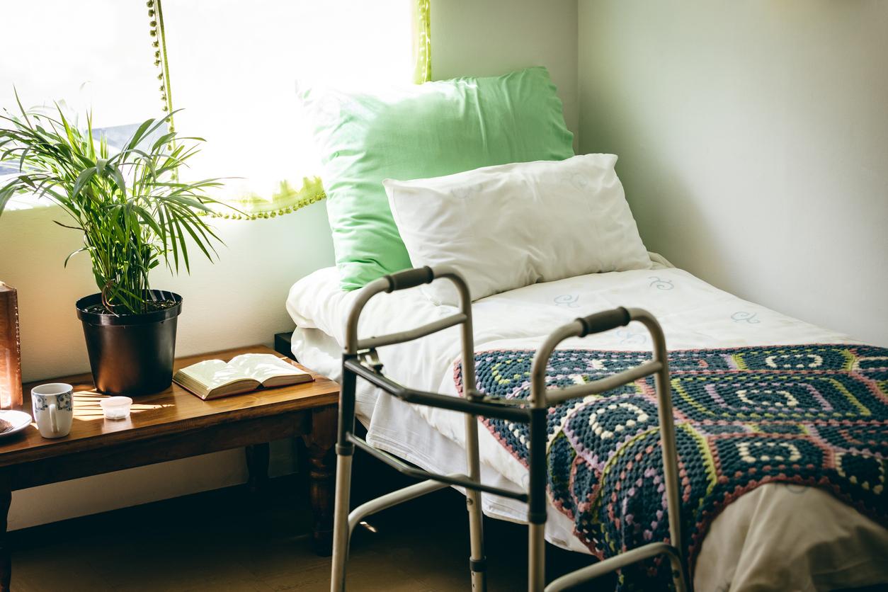 Empty bed and walker in care home